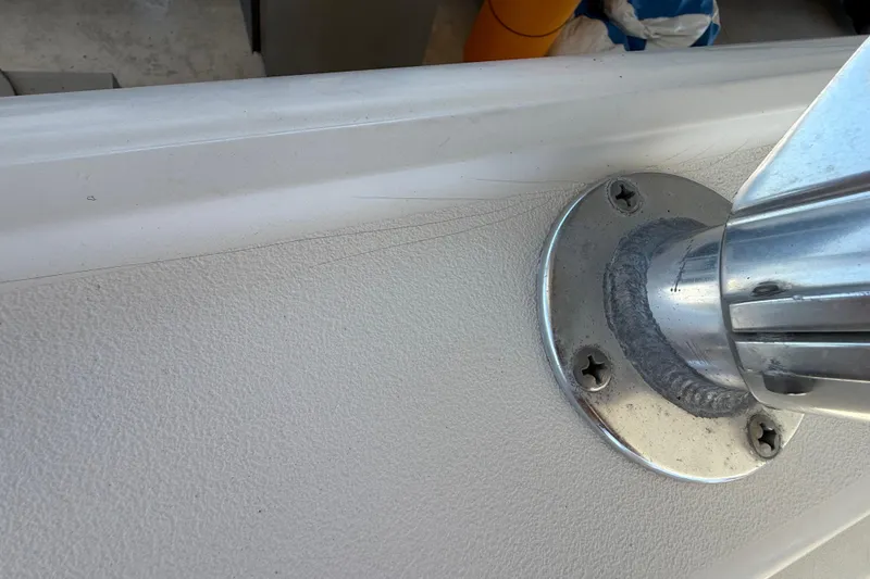 Slide: The Image of Close-up of a 2008 Intrepid 377 Walkaround boat's metal fixture on textured surface. - 212