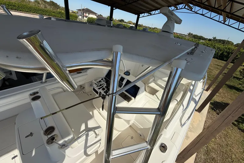 Slide: The Image of 2008 Intrepid 377 Walkaround boat interior with helm and seating under a canopy. - 214