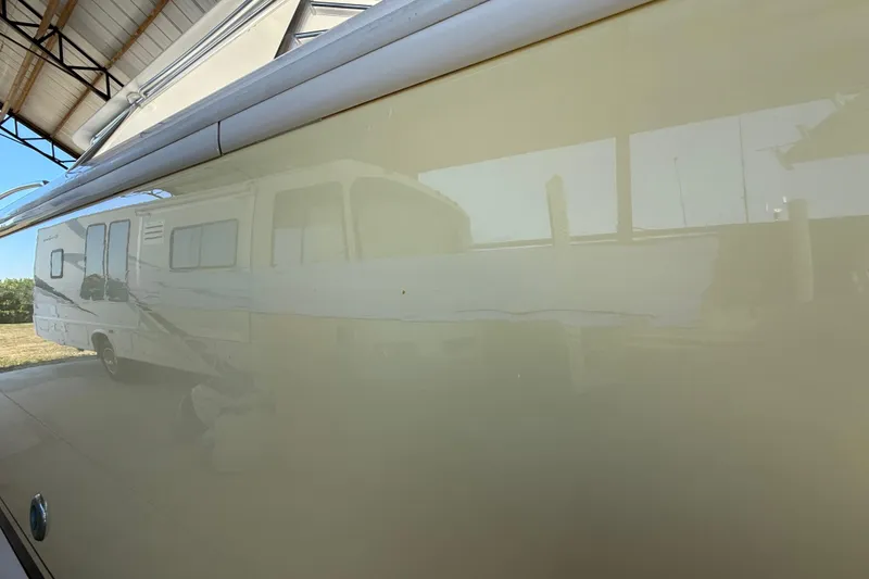 Slide: The Image of 2008 Intrepid 377 Walkaround boat reflecting RV in storage facility. - 219