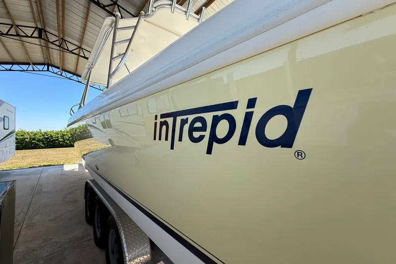 Slide: The Image of 2008 Intrepid 377 Walkaround boat in storage, showcasing sleek design and logo. - 22