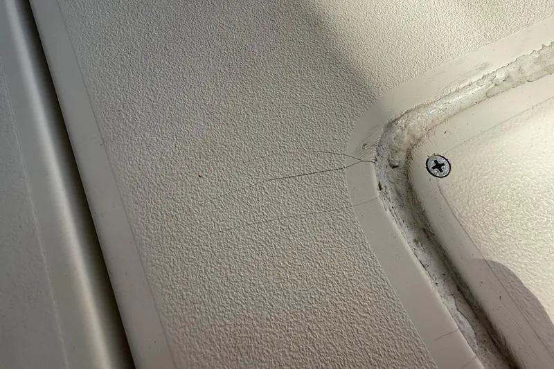 Slide: The Image of Close-up of 2008 Intrepid 377 Walkaround boat surface with visible scratches and screw. - 224