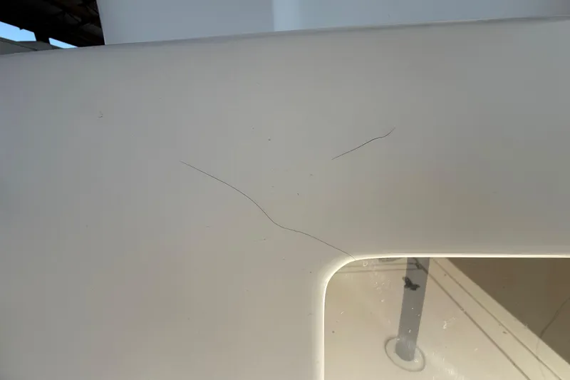 Slide: The Image of Close-up of a 2008 Intrepid 377 Walkaround boat surface with visible scratches. - 226