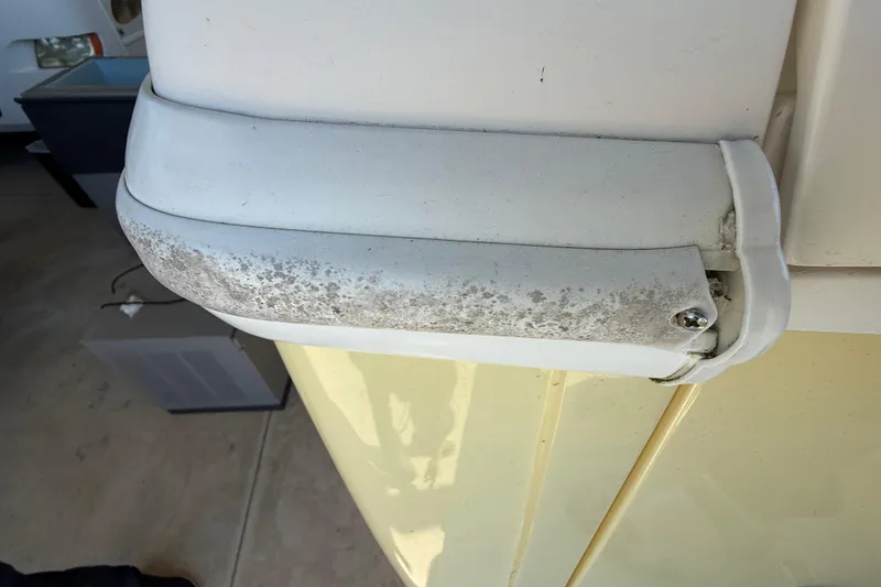 Slide: The Image of Close-up of a 2008 Intrepid 377 Walkaround boat's weathered white fixture. - 230