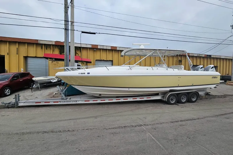 Slide: The Image of 2008 Intrepid 377 Walkaround boat under a metal canopy, front view. - 3