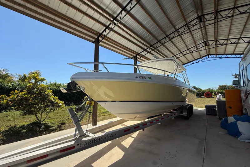 Slide: The Image of 2008 Intrepid 377 Walkaround boat on trailer under metal canopy. - 4