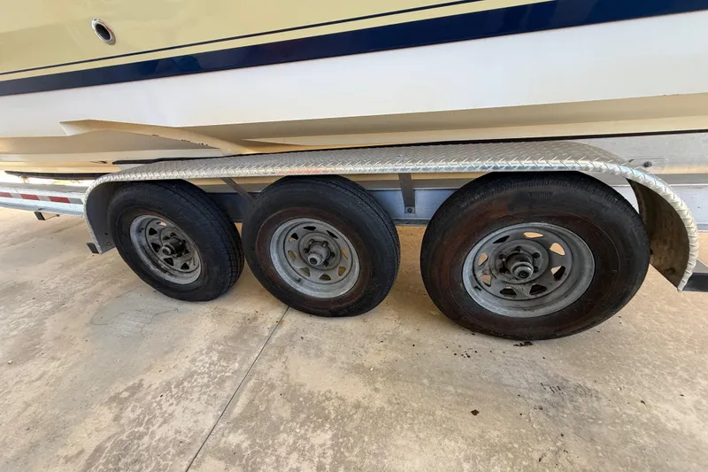 Slide: The Image of Trailer with three wheels supporting a 2008 Intrepid 377 Walkaround boat. - 41