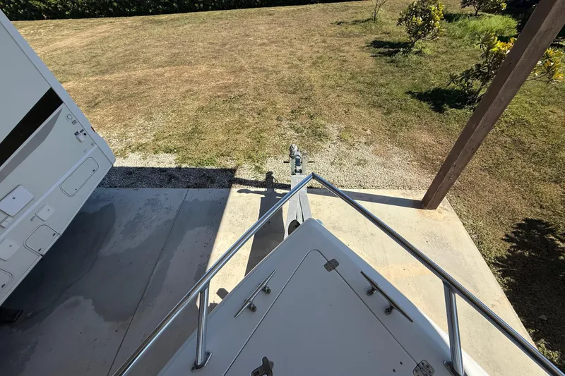 Slide: The Image of Bow view of 2008 Intrepid 377 Walkaround boat on a concrete pad near grassy area. - 52