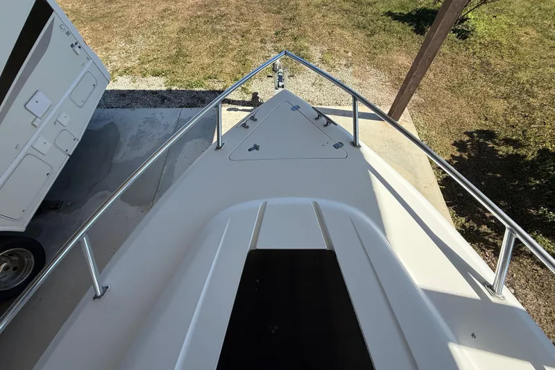 Slide: The Image of 2008 Intrepid 377 Walkaround boat bow, parked on concrete, with adjacent trailer. - 55