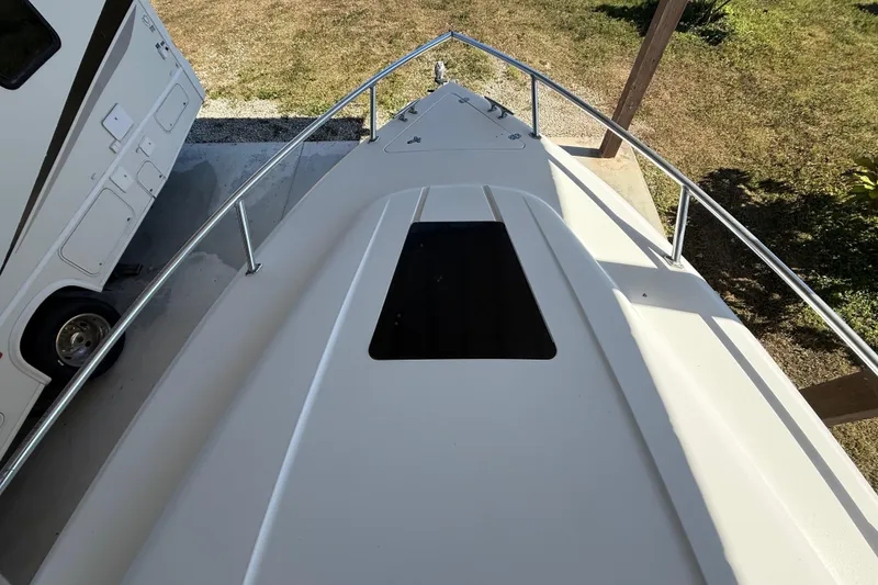 Slide: The Image of 2008 Intrepid 377 Walkaround boat deck with railing, parked beside an RV. - 57