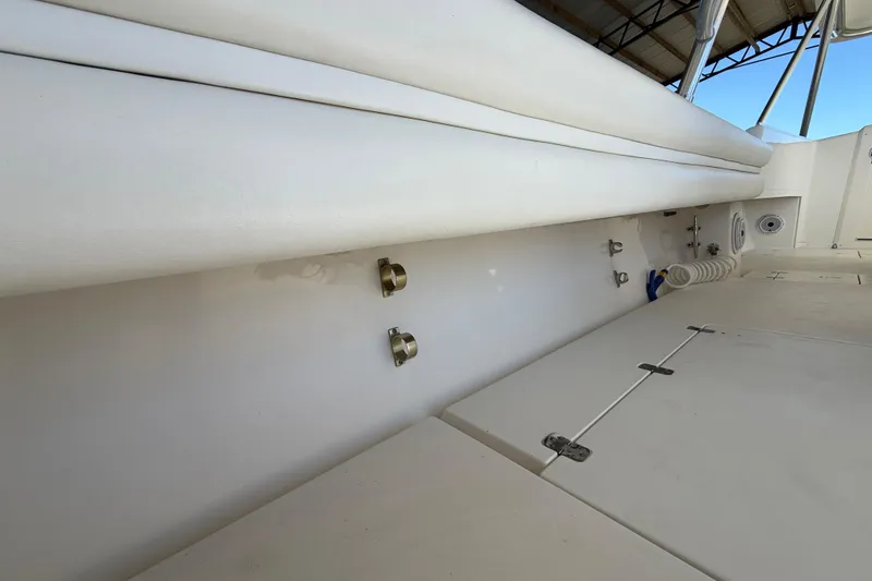 Slide: The Image of 2008 Intrepid 377 Walkaround boat interior with white seating and deck details. - 65