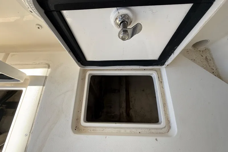 Slide: The Image of Storage compartment on a 2008 Intrepid 377 Walkaround boat, featuring a secure latch. - 72