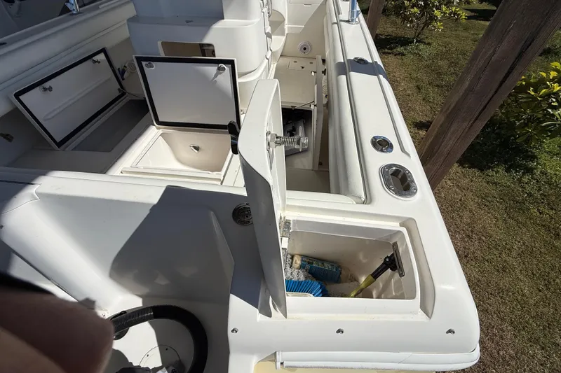 Slide: The Image of 2008 Intrepid 377 Walkaround boat with open storage compartments and clean white deck. - 73