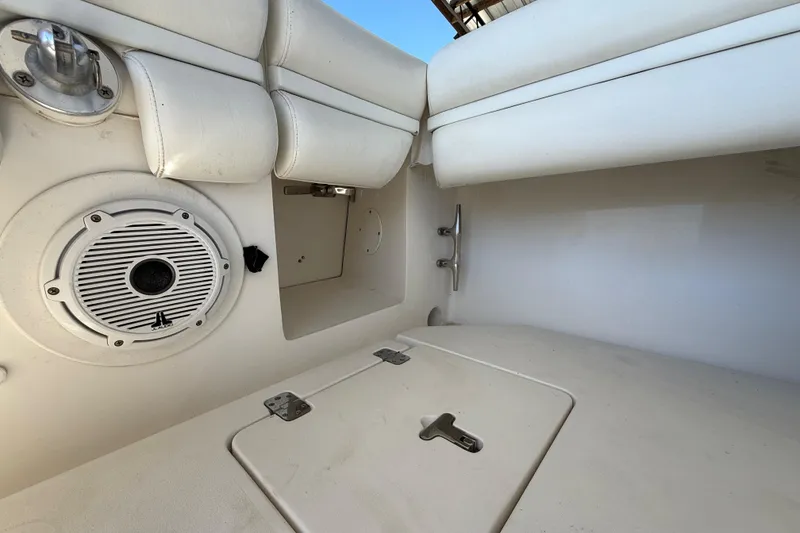 Slide: The Image of 2008 Intrepid 377 Walkaround interior with speaker, storage, and white seating. - 78