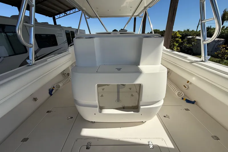 Slide: The Image of 2008 Intrepid 377 Walkaround boat interior with white deck and storage compartments. - 82