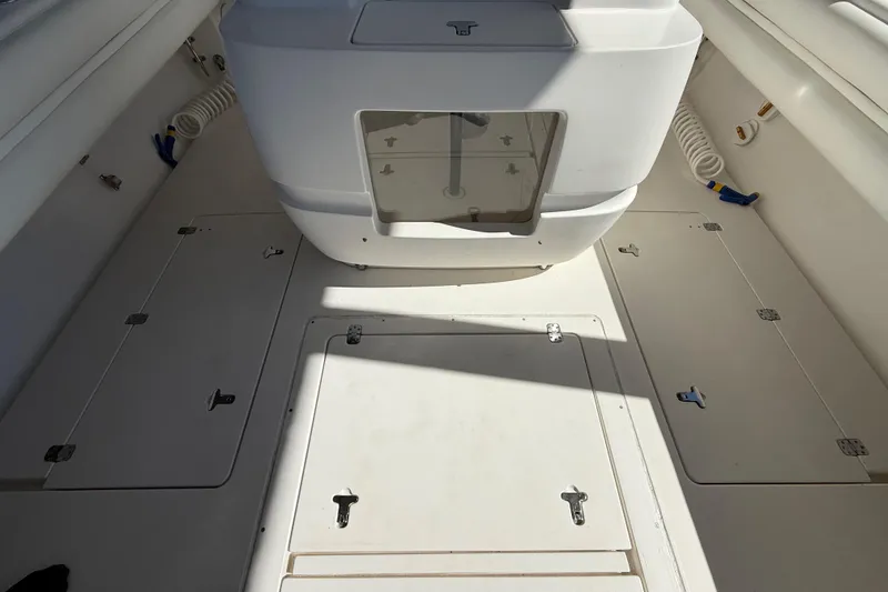 Slide: The Image of 2008 Intrepid 377 Walkaround boat deck with storage compartments and clean white finish. - 83