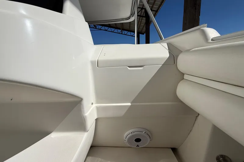 Slide: The Image of Interior view of a 2008 Intrepid 377 Walkaround boat, featuring white seating and speaker. - 87