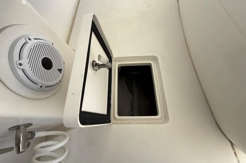 Slide: The Image of 2008 Intrepid 377 Walkaround boat interior with open storage compartment and speaker. - 91