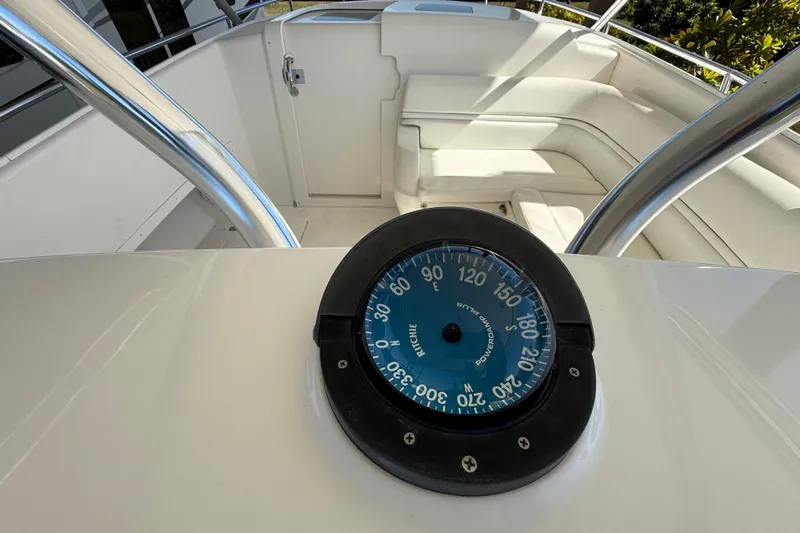 Slide: The Image of 2008 Intrepid 377 Walkaround boat interior with compass and seating area. - 93