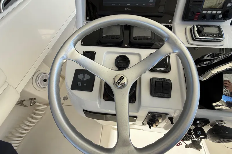 Slide: The Image of Steering wheel and controls of a 2008 Intrepid 377 Walkaround boat. - 98