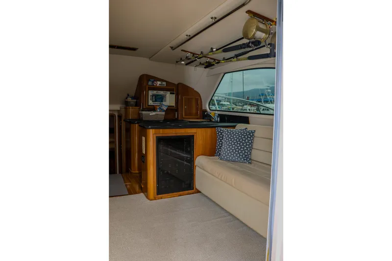 Slide: The Image of Interior of 2001 Black Watch 40 yacht with seating, fishing rods, and control panel. - 10