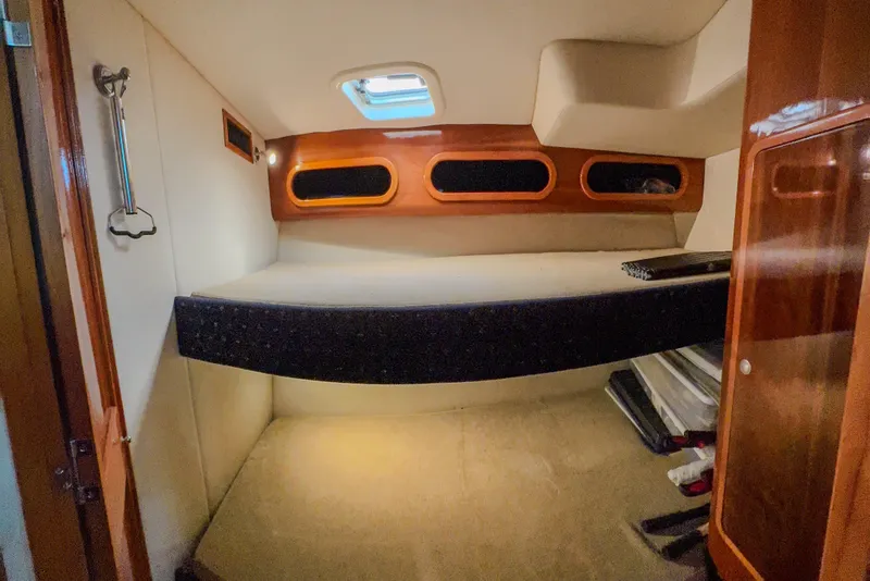 Slide: The Image of Cozy cabin interior of 2001 Black Watch 40 boat with wooden accents and porthole windows. - 13