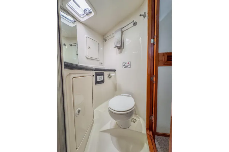 Slide: The Image of Compact bathroom in 2001 Black Watch 40 yacht, featuring toilet and storage. - 15