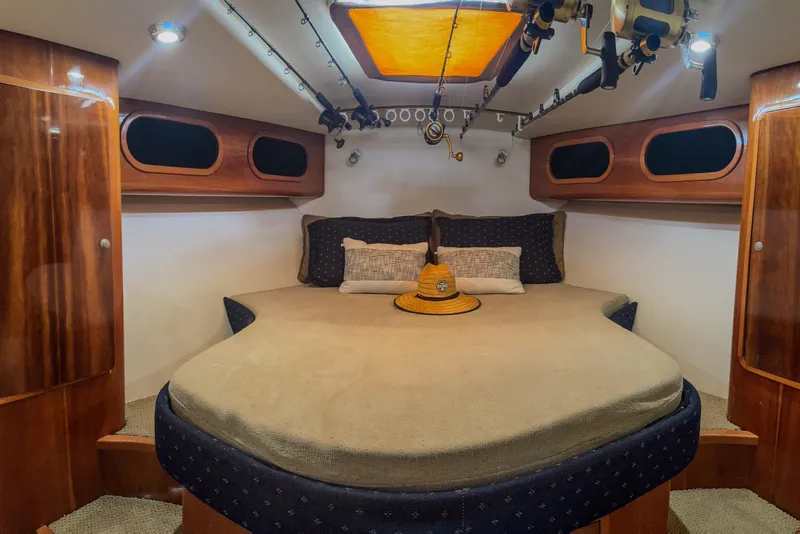 Slide: The Image of Luxurious cabin interior of 2001 Black Watch 40 boat with cozy bed and fishing rods. - 17