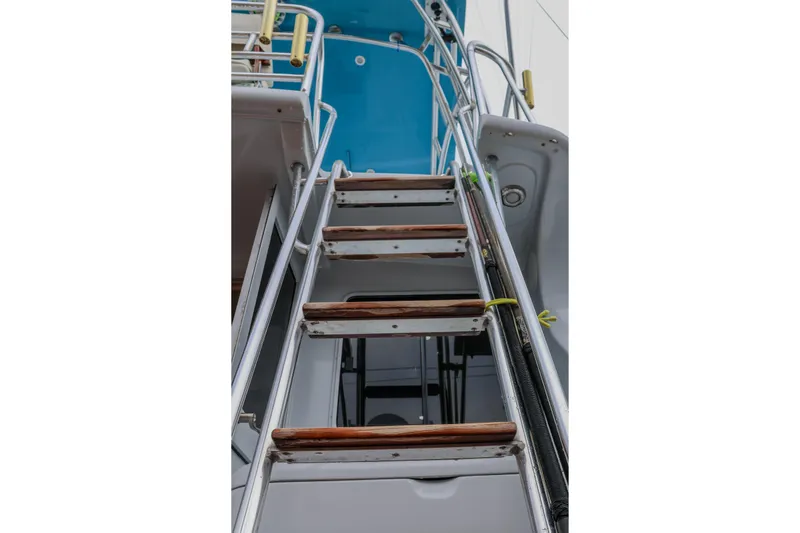 Slide: The Image of Staircase on 2001 Black Watch 40 yacht with wooden steps and metal railings. - 19