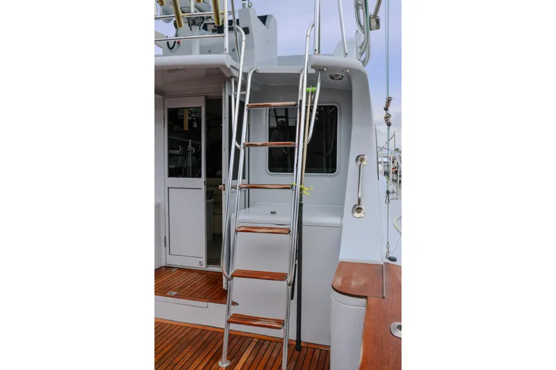 Slide: The Image of 2001 Black Watch 40 yacht ladder and deck, featuring sleek design and wooden accents. - 20