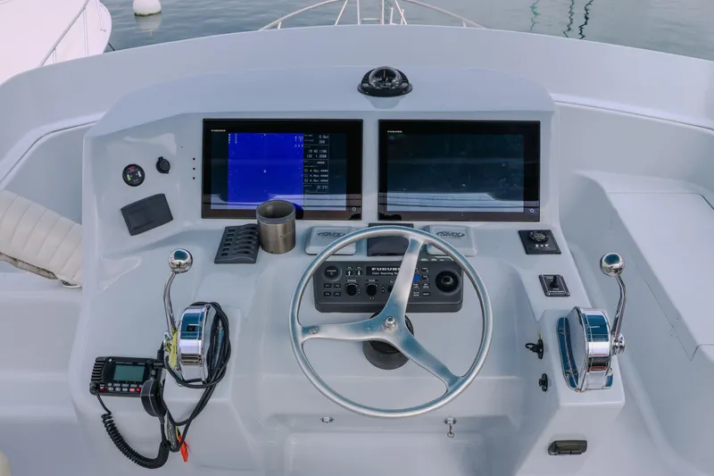 Slide: The Image of Helm of 2001 Black Watch 40 boat with dual screens and steering wheel. - 21