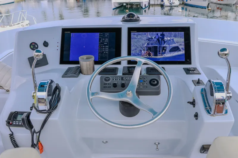 Slide: The Image of Helm of 2001 Black Watch 40 boat with dual screens and controls. - 24