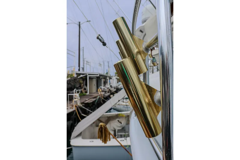 Slide: The Image of Gold rod holders on a 2001 Black Watch 40 boat at a marina. - 25