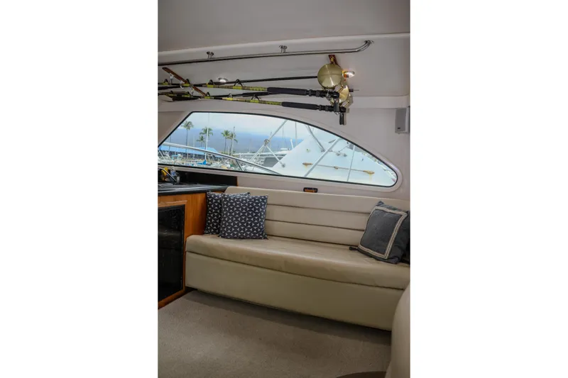 Slide: The Image of Interior of 2001 Black Watch 40 yacht with beige seating and fishing rods. - 9