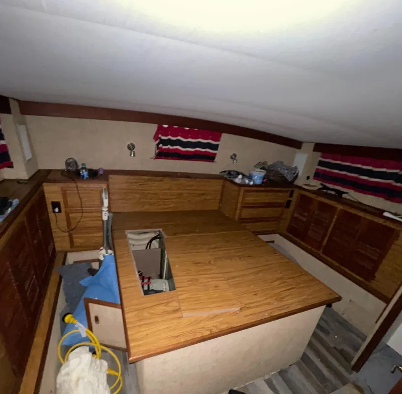 Slide: The Image of Interior of 1979 Viking 43 Double Cabin with wood cabinetry and striped curtains. - 19