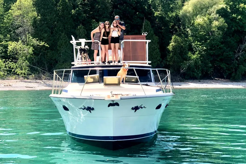 Slide: The Image of 1979 Viking 43 Double Cabin yacht on clear water with people and a dog onboard. - 4