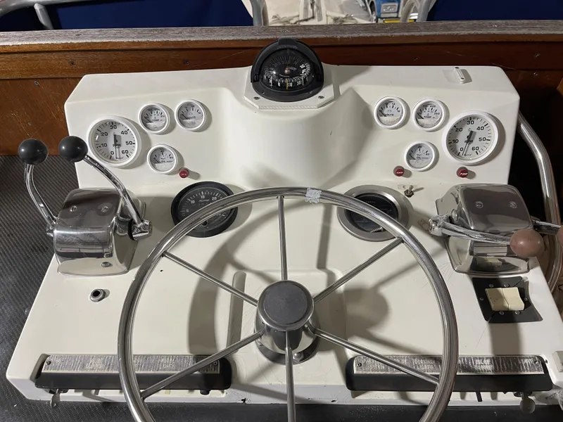 Slide: The Image of 1979 Viking 43 Double Cabin helm with gauges, steering wheel, and controls. - 6