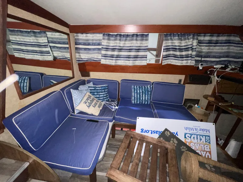 Slide: The Image of Interior of 1979 Viking 43 Double Cabin with blue seating and striped curtains. - 9
