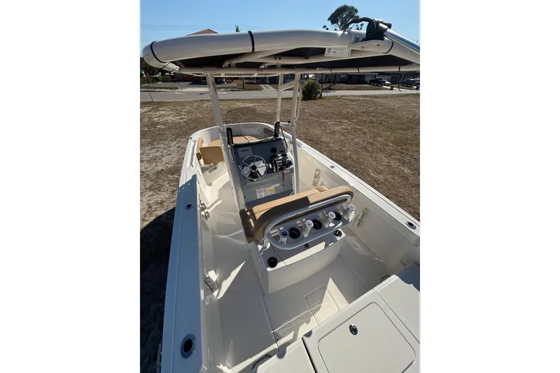 Slide: The Image of 2026 Bayliner Trophy T22CC boat interior with helm, seating, and rod holders. - 16