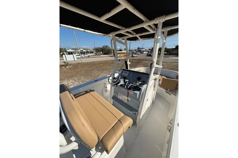 Slide: The Image of 2026 Bayliner Trophy T22CC boat interior with helm and seating, showcasing modern design. - 23