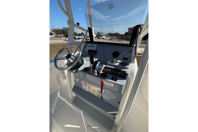 Slide: The Image of 2026 Bayliner Trophy T22CC boat console with steering wheel and controls. - 24