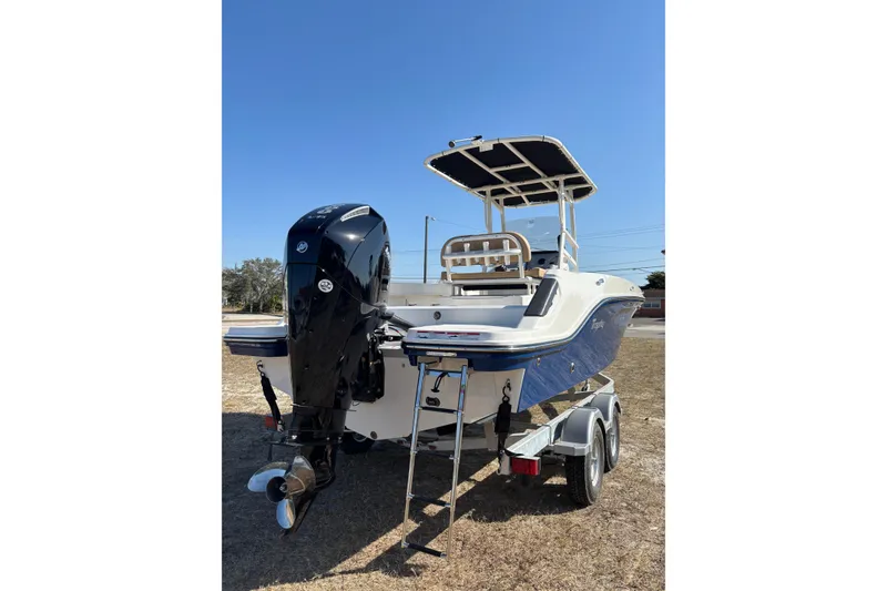 Slide: The Image of 2026 Bayliner Trophy T22CC boat on trailer, rear view with outboard motor. - 32