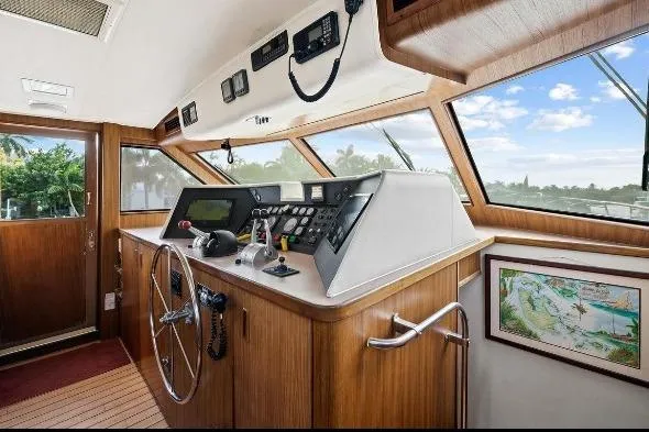 Slide: The Image of 1989 Hatteras 70 Motor Yacht helm with wooden interior and navigation controls. - 13