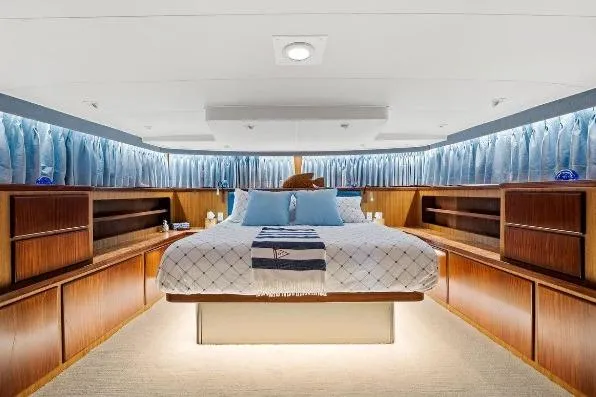Slide: The Image of Luxurious bedroom interior of 1989 Hatteras 70 Motor Yacht with elegant wood finishes. - 14