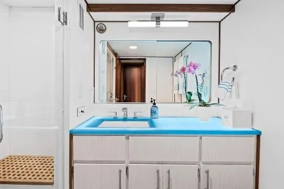 Slide: The Image of Bathroom interior of 1989 Hatteras 70 Motor Yacht with blue countertop and mirror. - 17
