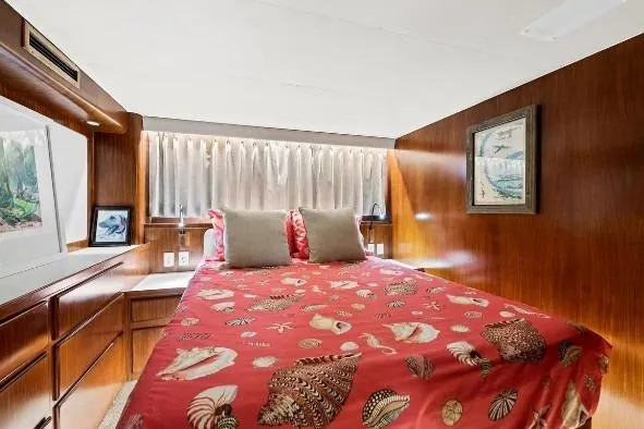Slide: The Image of Luxurious bedroom interior of 1989 Hatteras 70 Motor Yacht with seashell-themed bedding. - 19