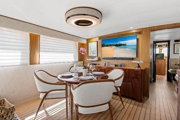 Slide: The Image of Luxurious interior of 1989 Hatteras 70 Motor Yacht with elegant dining area and modern decor. - 5