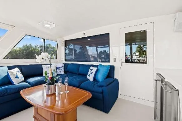 Slide: The Image of Luxurious interior of 1989 Hatteras 70 Motor Yacht with blue seating and elegant decor. - 8
