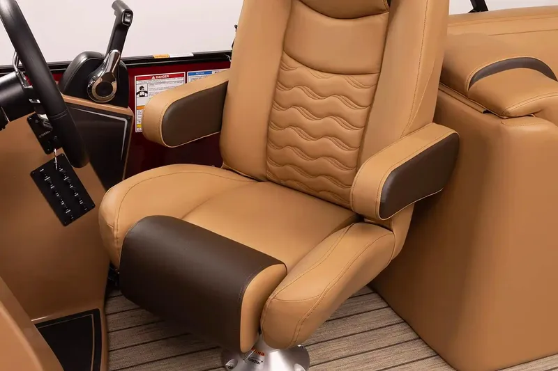 Slide: The Image of Luxurious tan captain's chair in 2026 SunCatcher Fusion 324SS boat interior. - 8
