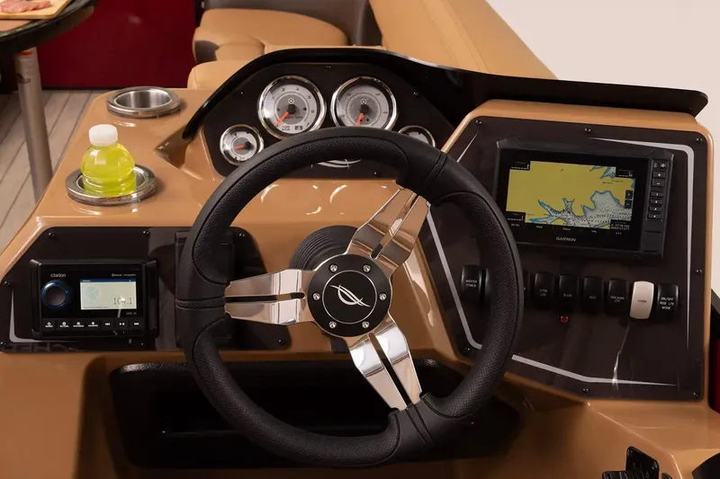 Slide: The Image of 2026 SunCatcher Fusion 324SS boat dashboard with steering wheel, gauges, and navigation system. - 9