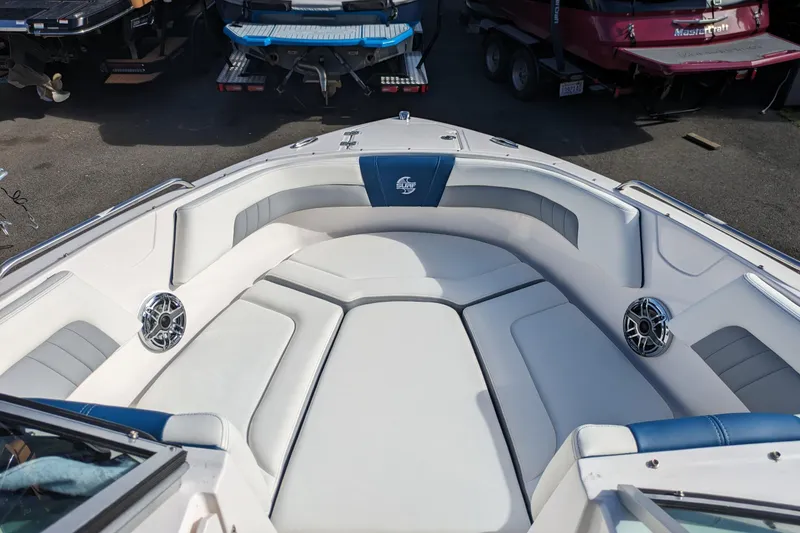 Slide: The Image of 2023 Chaparral 23 Surf boat interior with cushioned seating and speakers. - 10